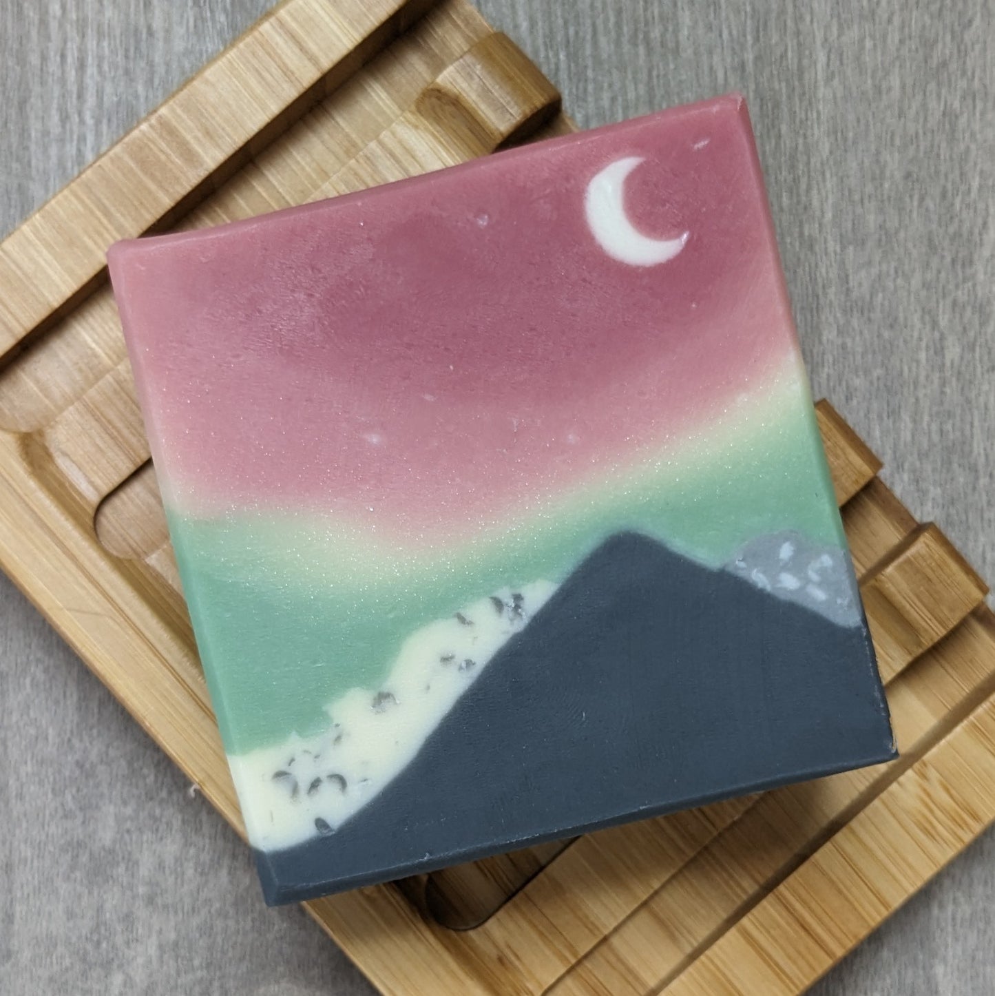 Soap with mountain design and green and red sky