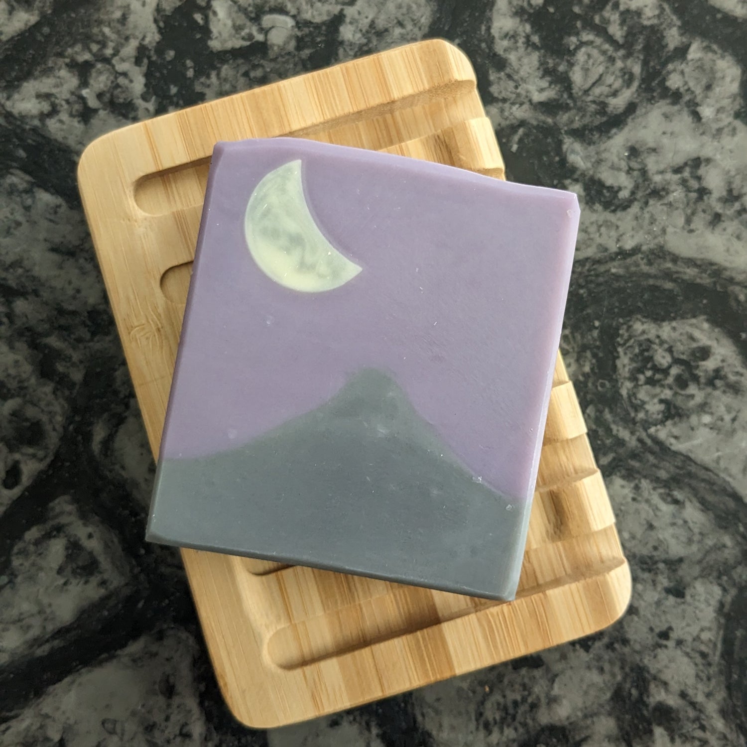 Soap with mountain, purple sky and moon design on soap dish